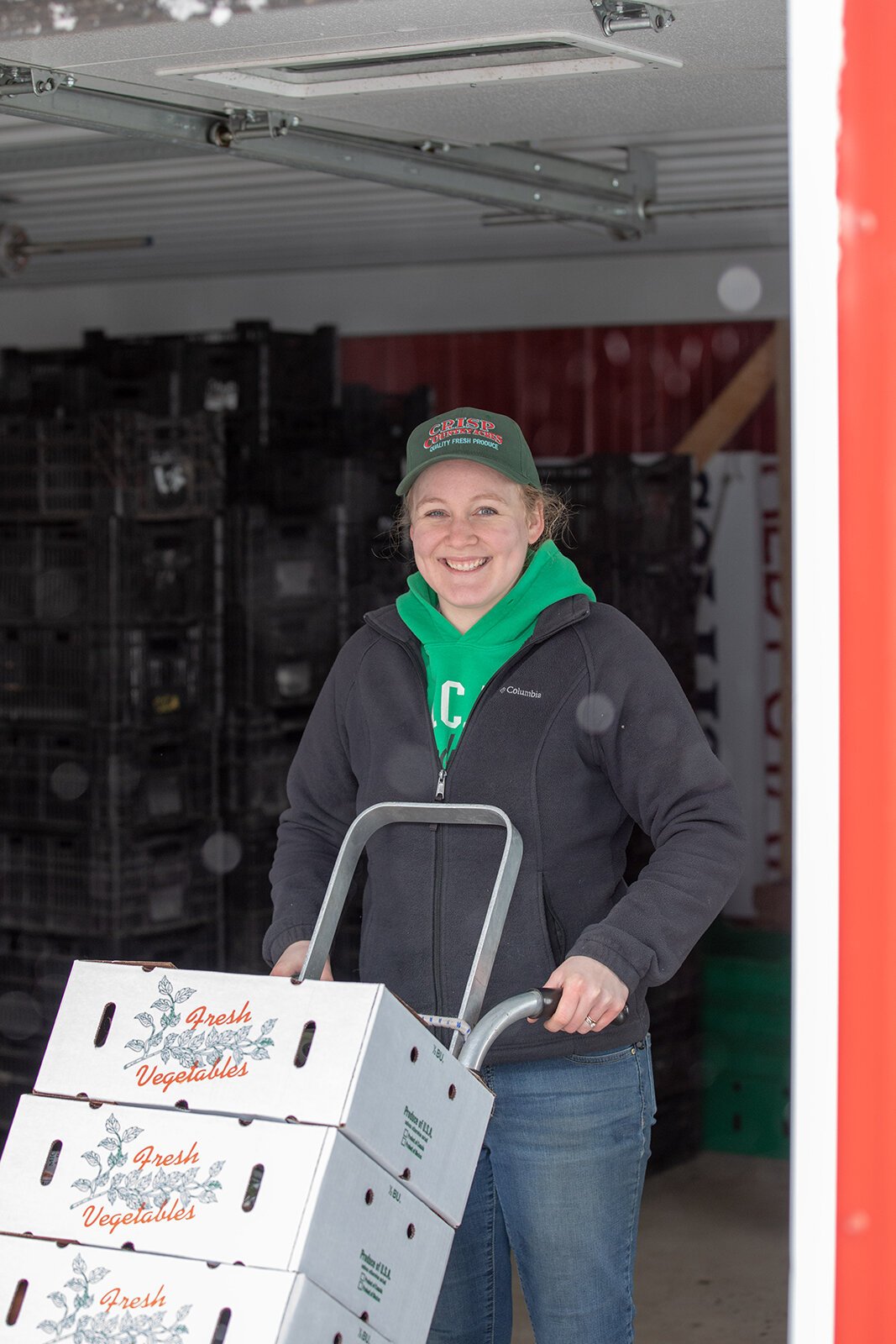 A farmer loads a truck with fresh vegetables for a local food pantry.