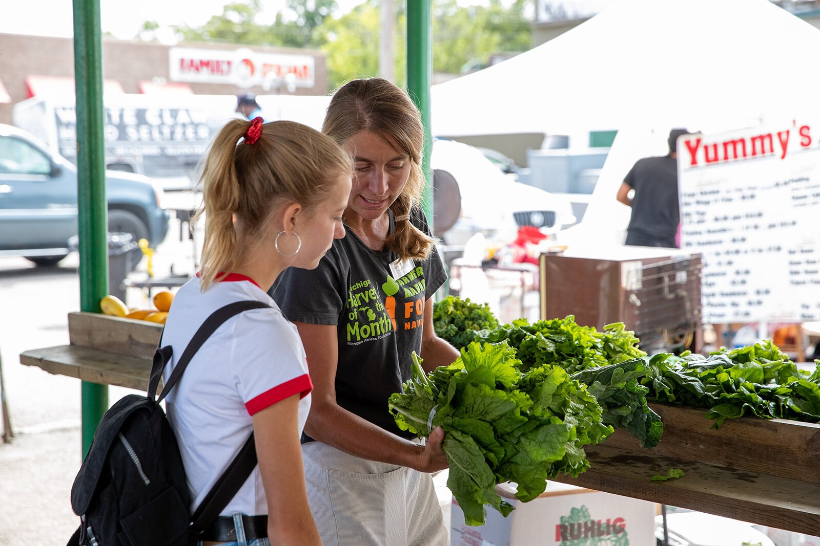Amy St. Germain talks to visitors at the Muskegon Farmers Market.