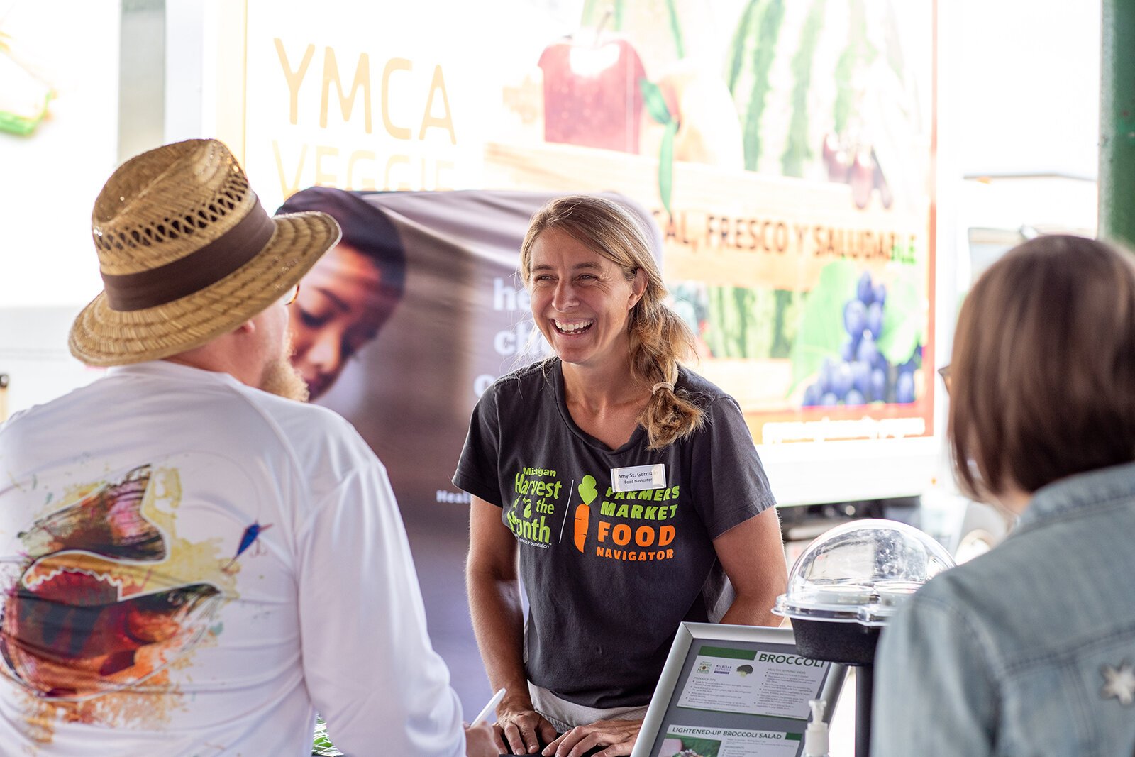 Amy St. Germain talks to visitors at the Muskegon Farmers Market.