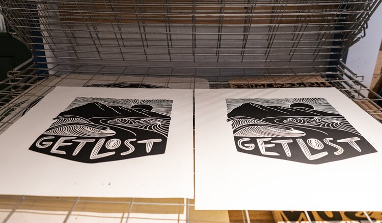 Prints made from artist Erica Lang's carvings lay out to dry.