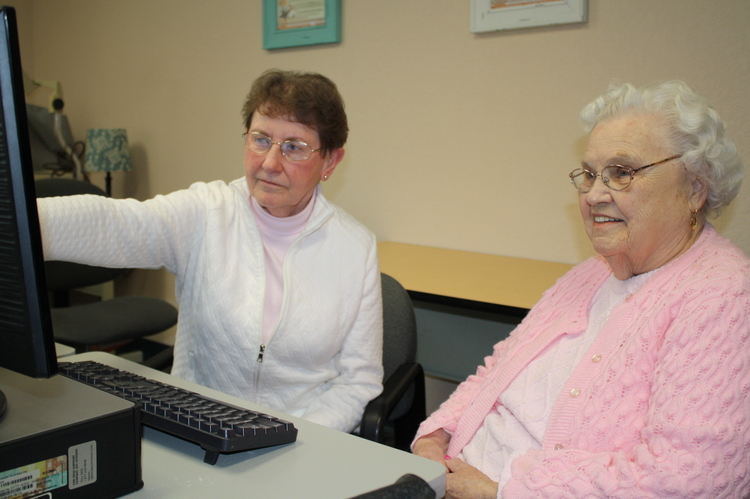 Betty (in pink) connects with her sister in the âold countryâ using CommunO2 with the help of Mary, a retired senior volunteer in Otsego County. Betty had not seen her sister in about 15 years.