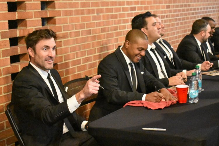 Michael Luginbill greets a returning fan of Straight No Chaser at Midland Center for the Arts during the merchandise signing on Nov. 30, 2024