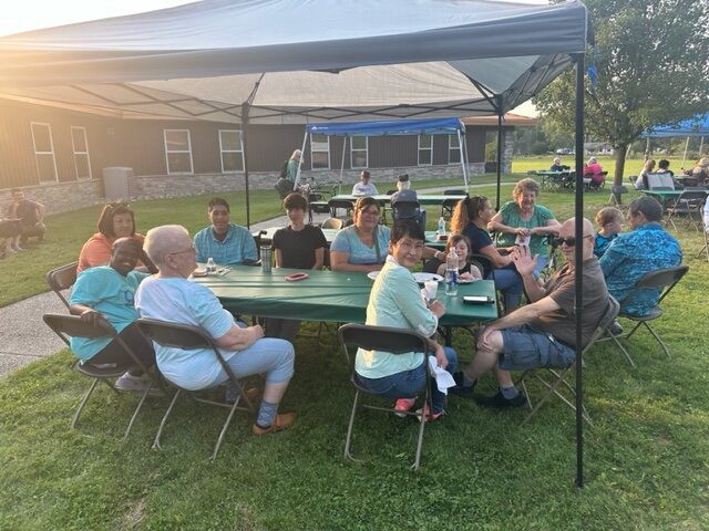 Residents gather to enjoy a pig roast