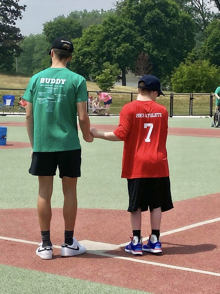 Middle of the Mitt Miracle League player with buddy