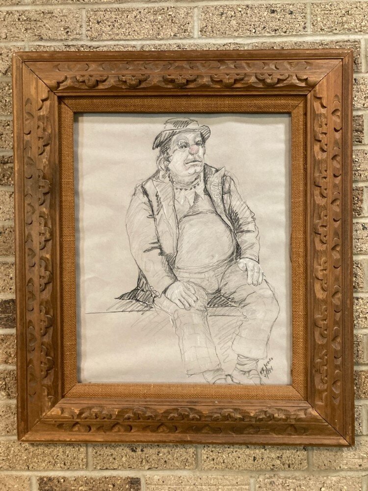 An image of John Pratt in his clown outfit hangs in the hallway at  Creative  360.
