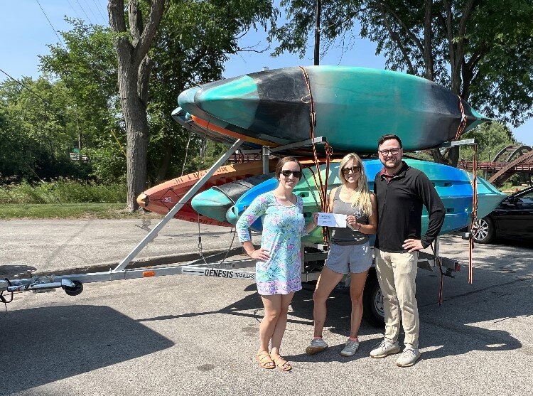 MYPros Marybeth Penkala and Kevin LaDuke present a check to Stacie Scherman, Nor'East Outdoors