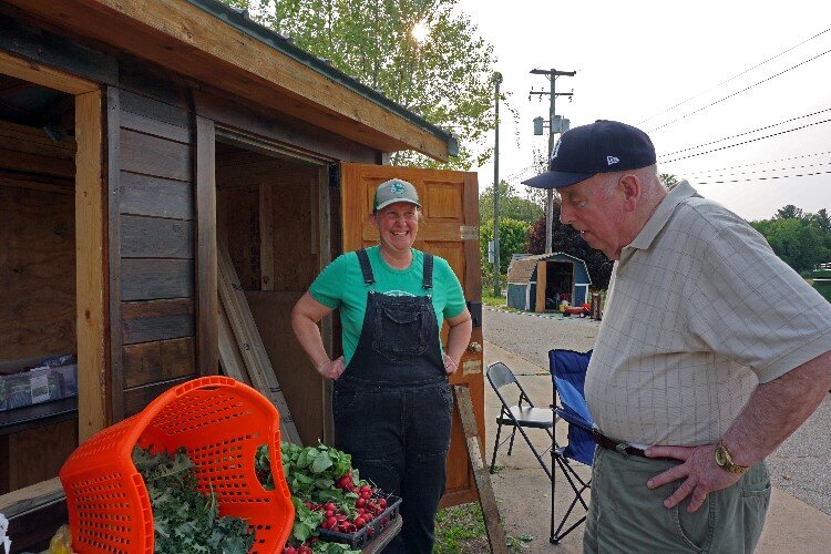 Volunteers help to manage the produce stands.