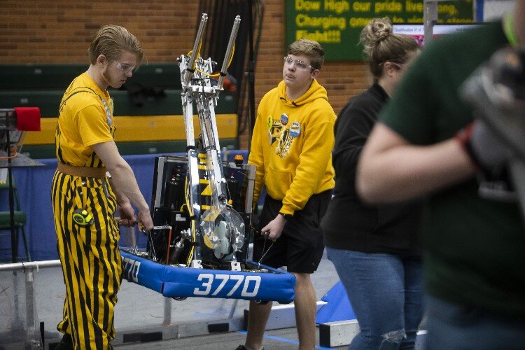 Members of "BlitzCreek" of Bullock Creek High School prepare to compete in a match during the FIRST.