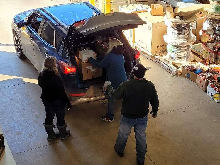 WMFC staff load up vehicles at the drive thru, food distribution event in 2021.