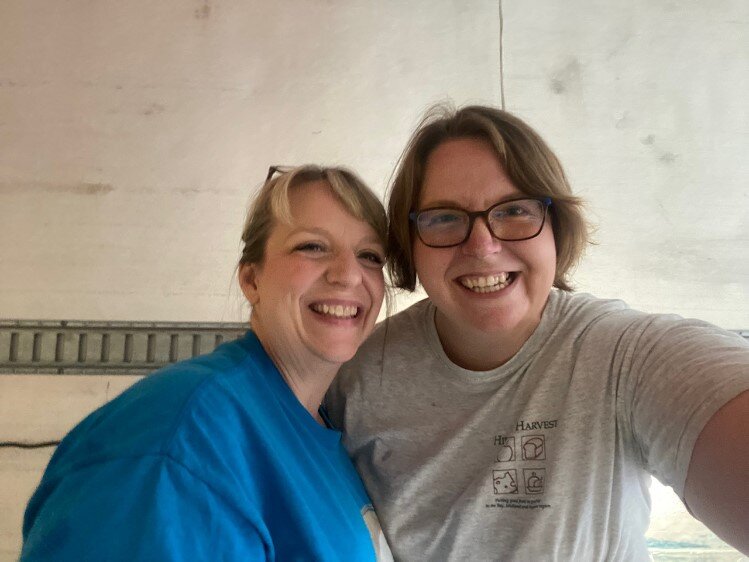 WMFC Helen Roth and Hidden Harvest Sam McKenzie in the back of a semi truck following the Dow Great Lakes Bay Invitational on site kitchen clean out
