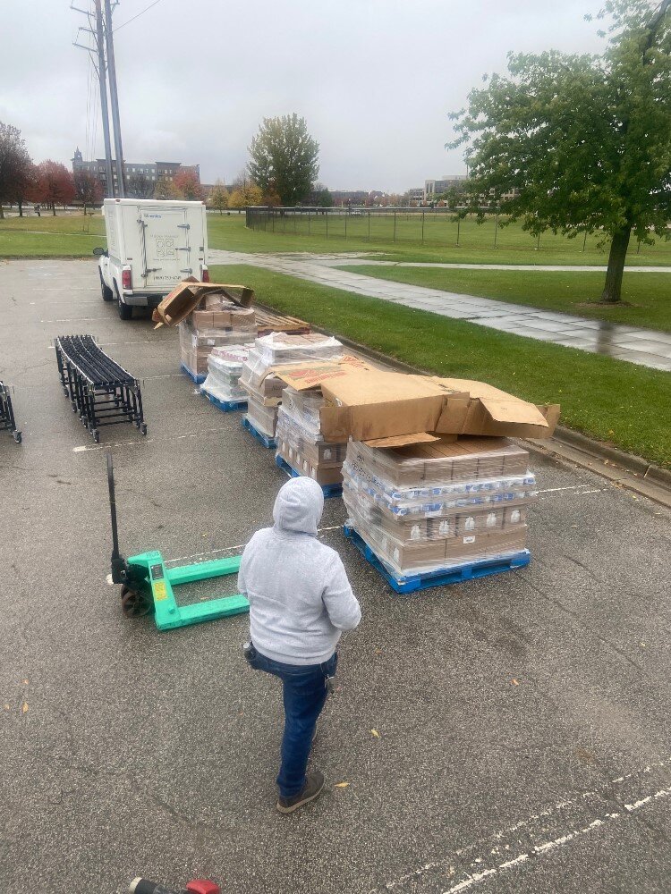 Program Assistant Chelsea Chansen setting up a food distribution in the rain in Bay County last week.