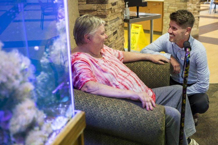 Pinecrest Farms Administrator Kory Priest, right, chats with Pinecrest resident Suzie Rutledge.