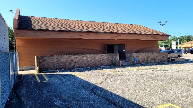 The outdoor patio will be located near the back parking lot.