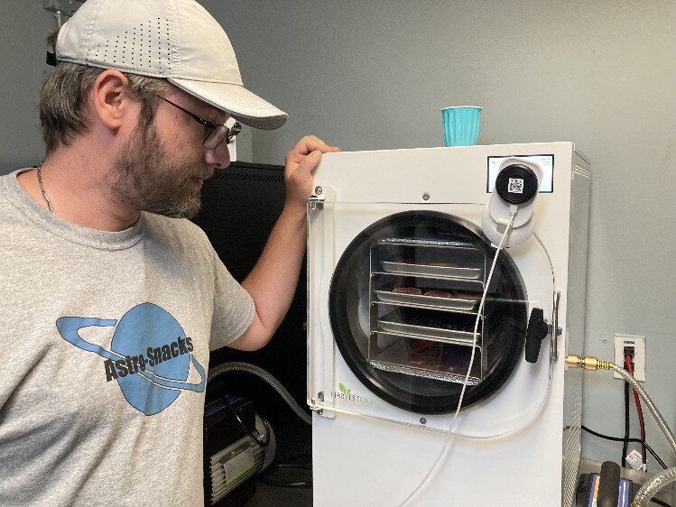 Andrew Eaves checking almost “done” orange slices and grapes.