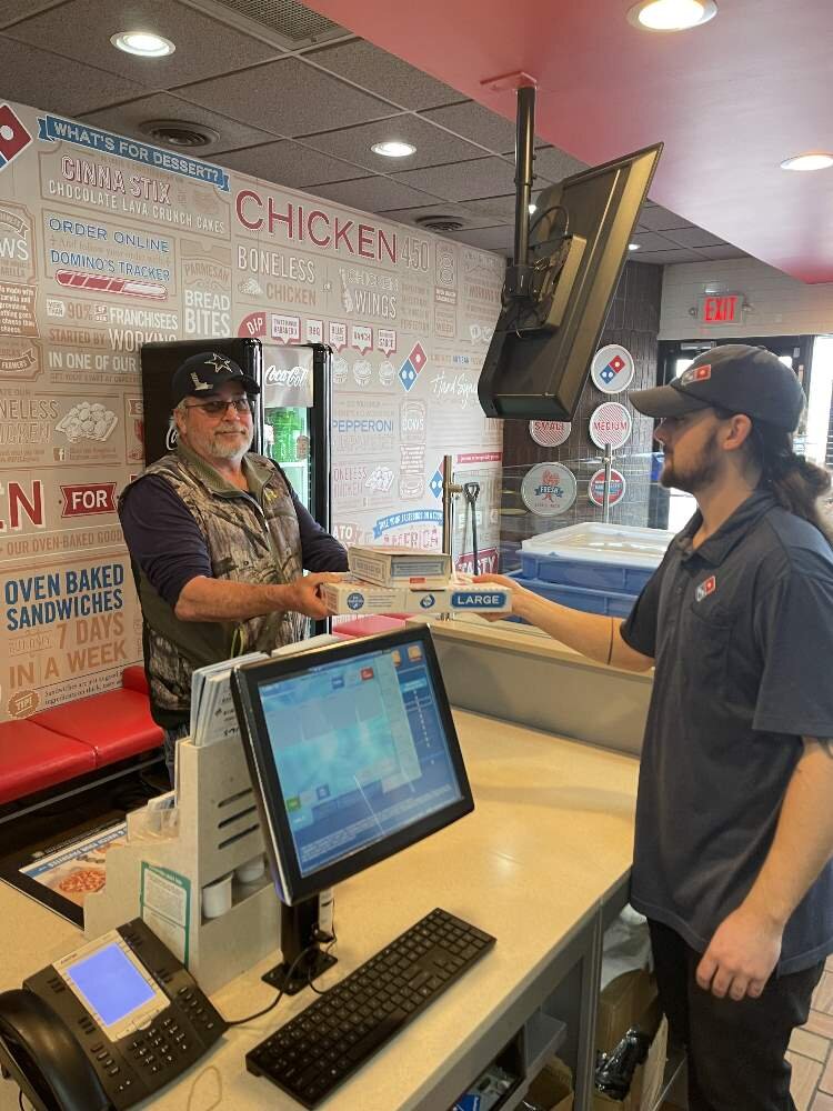 Midland Assistant Manager Jacob Glasgow serving a customer