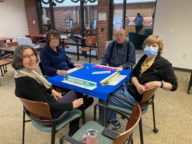 Clockwise are Joann Taylor (mask), Janice Valeri-Rose, Diane Popp and Jim Covieo in the Senior Center. The group, and others, gather twice weekly to play Mah Jongg, a four -player tile game.