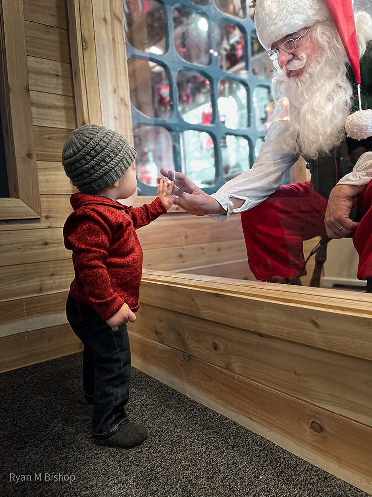 A protective barrier will remain between visitors and Santa.