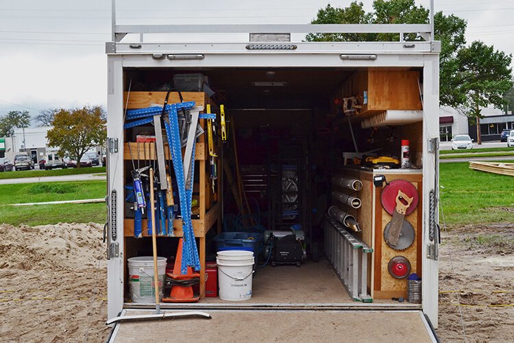 A truck brings the necessary tools and supplies to the building site.