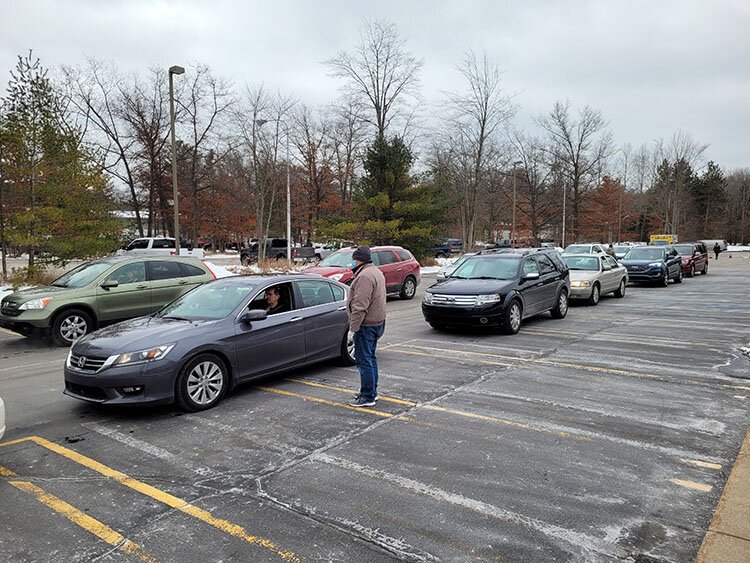 After receiving the vaccine at the drive-thru clinic, recipients sit in their cars for 15 minutes to be monitored for an immediate allergic reaction.