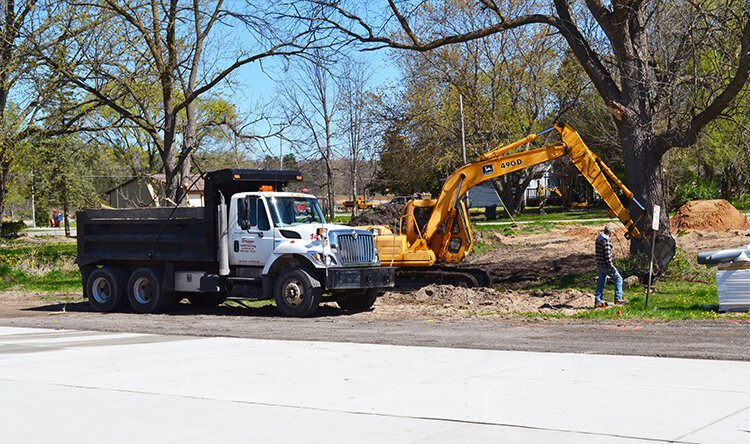 Sanford Hardware's parking lot is still under construction. Here, the crew is working on leveling the ground.