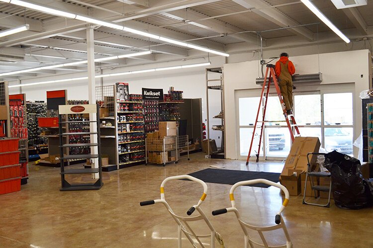 Work continues at Sanford Hardware between shelves filled with inventory.