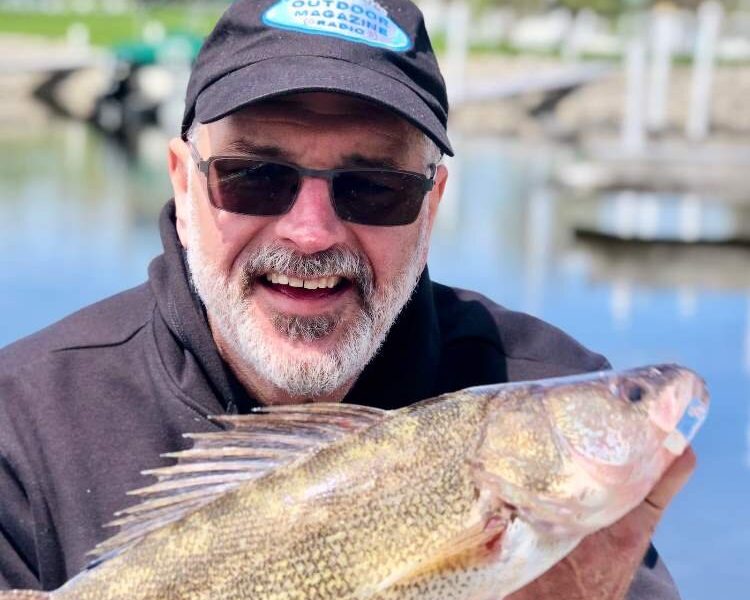 Mike Avery and his catch of the day, a walleye.