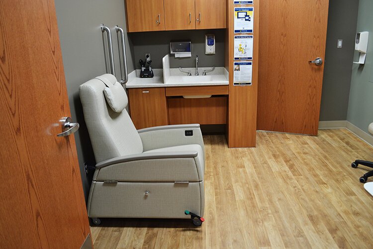 Patient rooms feature heated massage chairs that can fold out to function as exam tables.