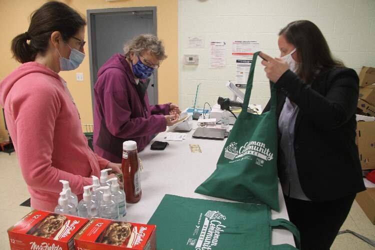 Hazel Rydman (center) checks out at the new market.