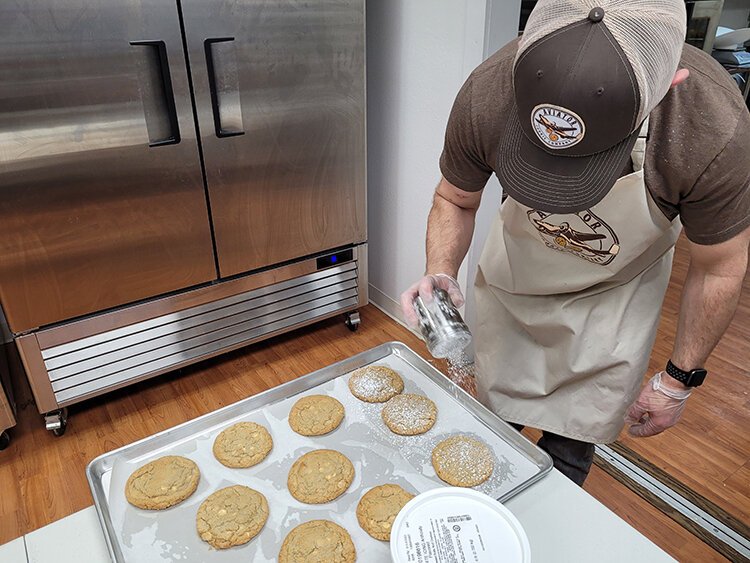 Chris Welch puts the finishing touch on a pan of cookies.