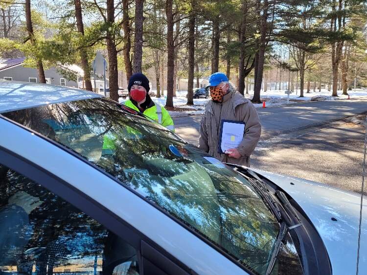 Ben Larson, facilities director, and Greg Dorrien, executive director, greet clients arriving at the food distribution event.