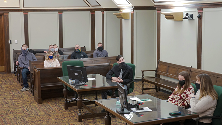 Matthew Wygant, center, and his friends listen as Zoom participants discuss their experiences with him since his admittance to the Midland County Honest Opportunity Probation with Enforcement (MiHOPE) program.