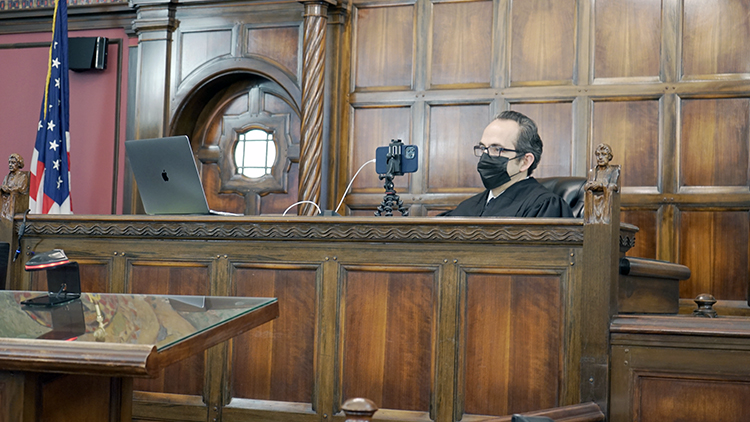 Carras listens as Wygant tells part of his story about his time in the MiHOPE program.