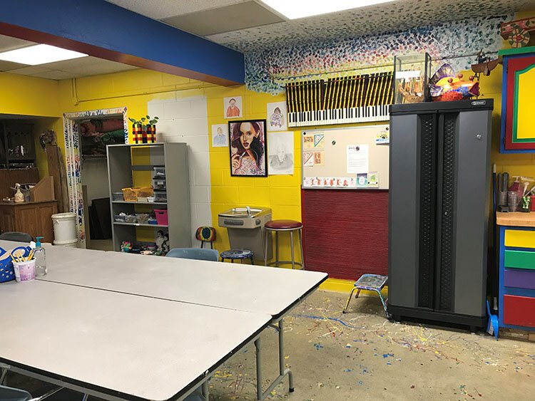 In the art room space downstairs, there’s now safe spacing at the work tables. The shelves and cabinets were donated from Horizon Bank.