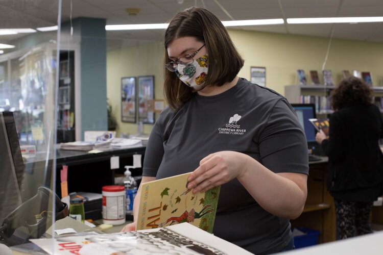 Veterans Memorial Library employee Jaclyn "Jackie" Prout prepares an order for a customer.