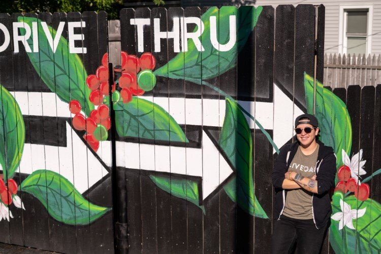 Benitez by her new mural noting the drive thru.