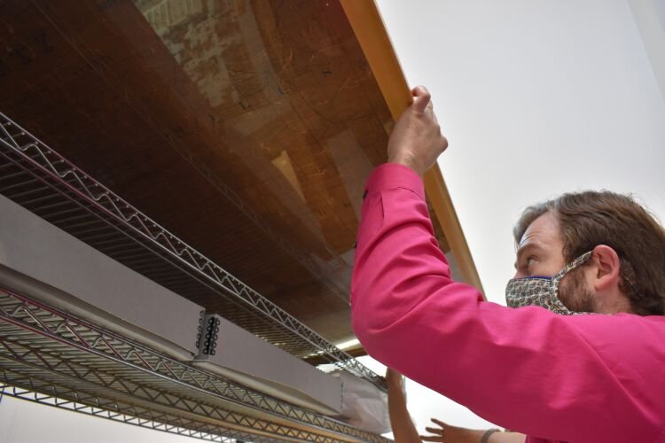 Jacob Huss, Historical Programs and Exhibits Manager with maps from Midland's collection.