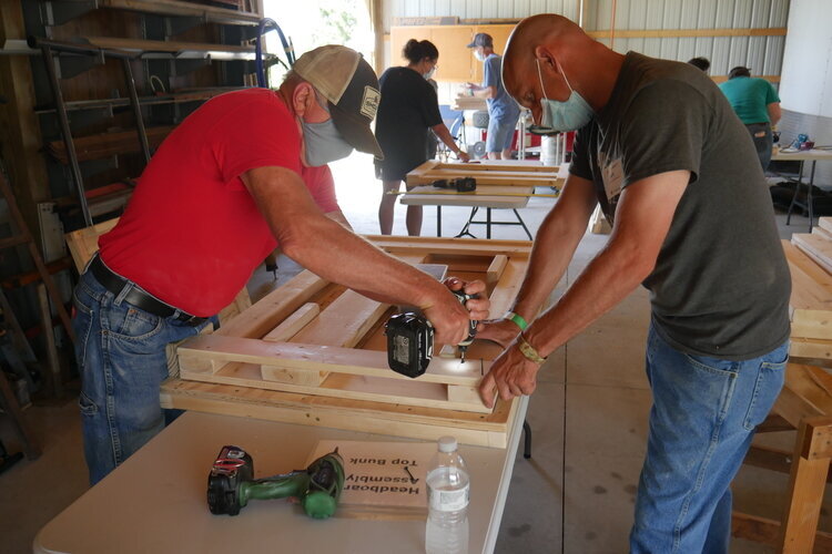 Volunteers from Auburn-based Sleep in Heavenly Place build bunk beds for kids without their own beds.