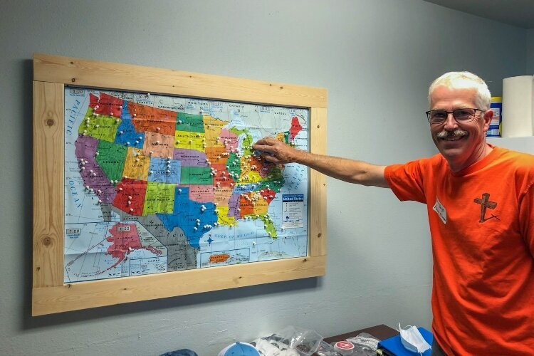 Brian Rueger traveled to Sleep in Heavenly Peace headquarters in Idaho to learn about the organization and its mission. Here, he puts a pin in the map to commemorate forming a chapter in Auburn.