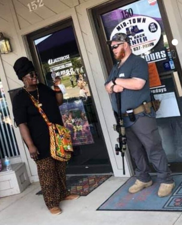 Erin Patrice talking to a man at Midland's Black Lives Matter Rally.