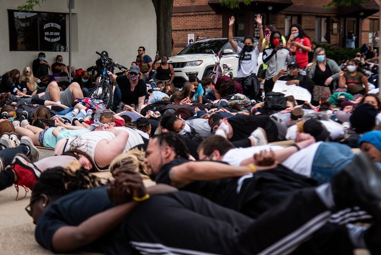 Protestors lie on the ground and chant, “I can’t breathe,” for nine minutes while others document during an event to protest the death of George Floyd and social injustice June 1 outside Isabella County Sheriff’s Office in Mount Pleasant, MI. 