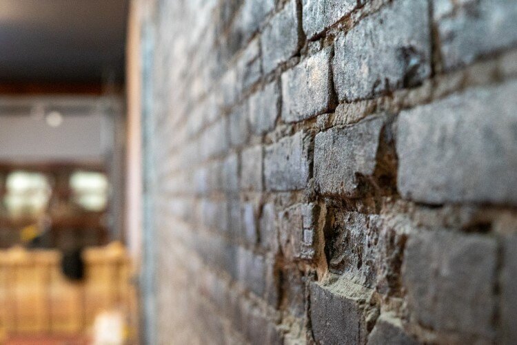 If you look closely, you'll see the character in a few areas of char left from the building's two previous fires.