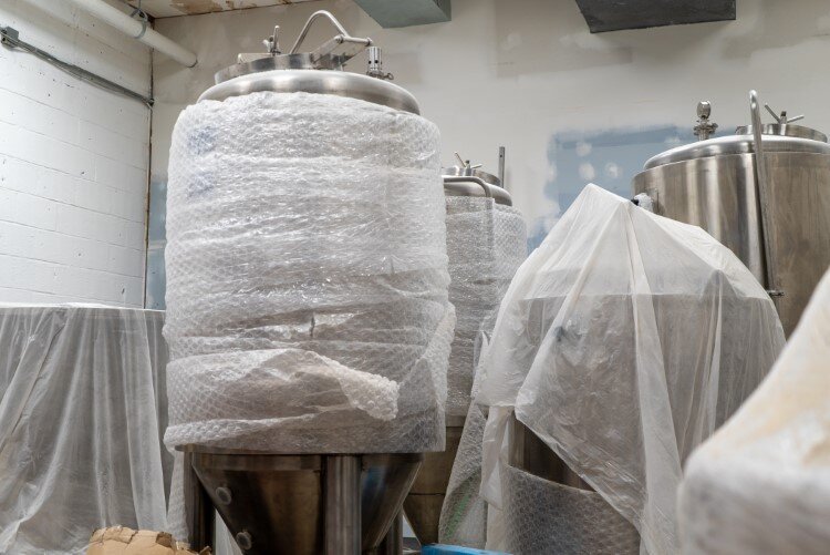 All the brewing equipment made it to the back room, thanks to a little help from Ace Hardware.