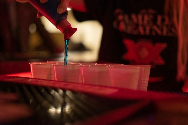 A bartender pours drinks at the Fire Bar