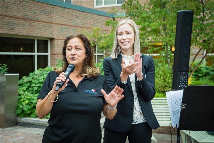 Julie Nunn, Executive Director of Cancer Services speaks to dinner guests as the event kicks off.