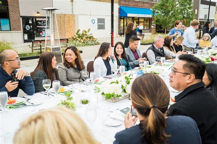Guests chat over dinner on Main Street in Downtown Midland.