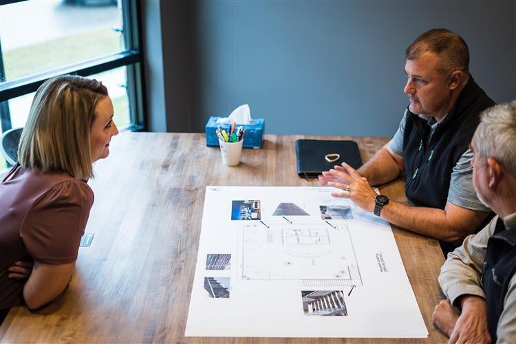 Jamie discussing plans with Three Rivers Corporation.