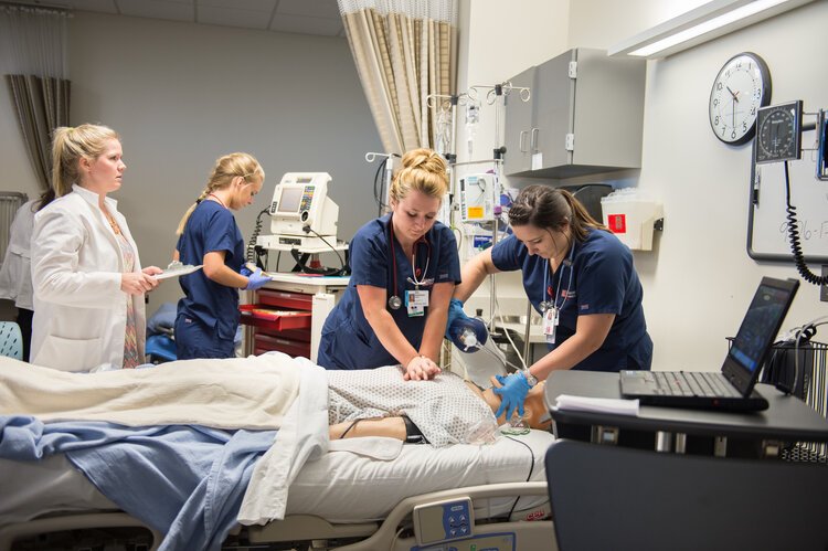 Students in Saginaw Valley State University’s nursing program practice hands-on skills in a lab setting.