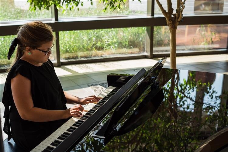 Evie Schram performed a piece before her sisters at MidMichigan Medical Center - Midland in August.