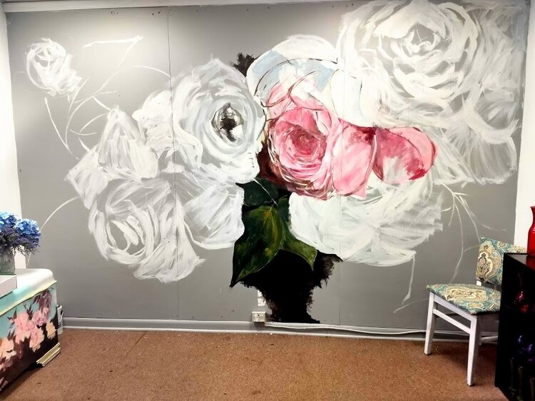 A large floral mural Tiffin has in progress. 