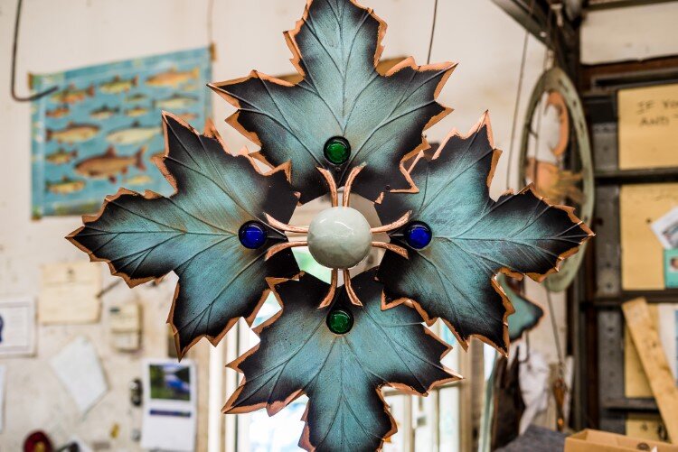 A finished copper piece hangs inside the Ardis Art studio.